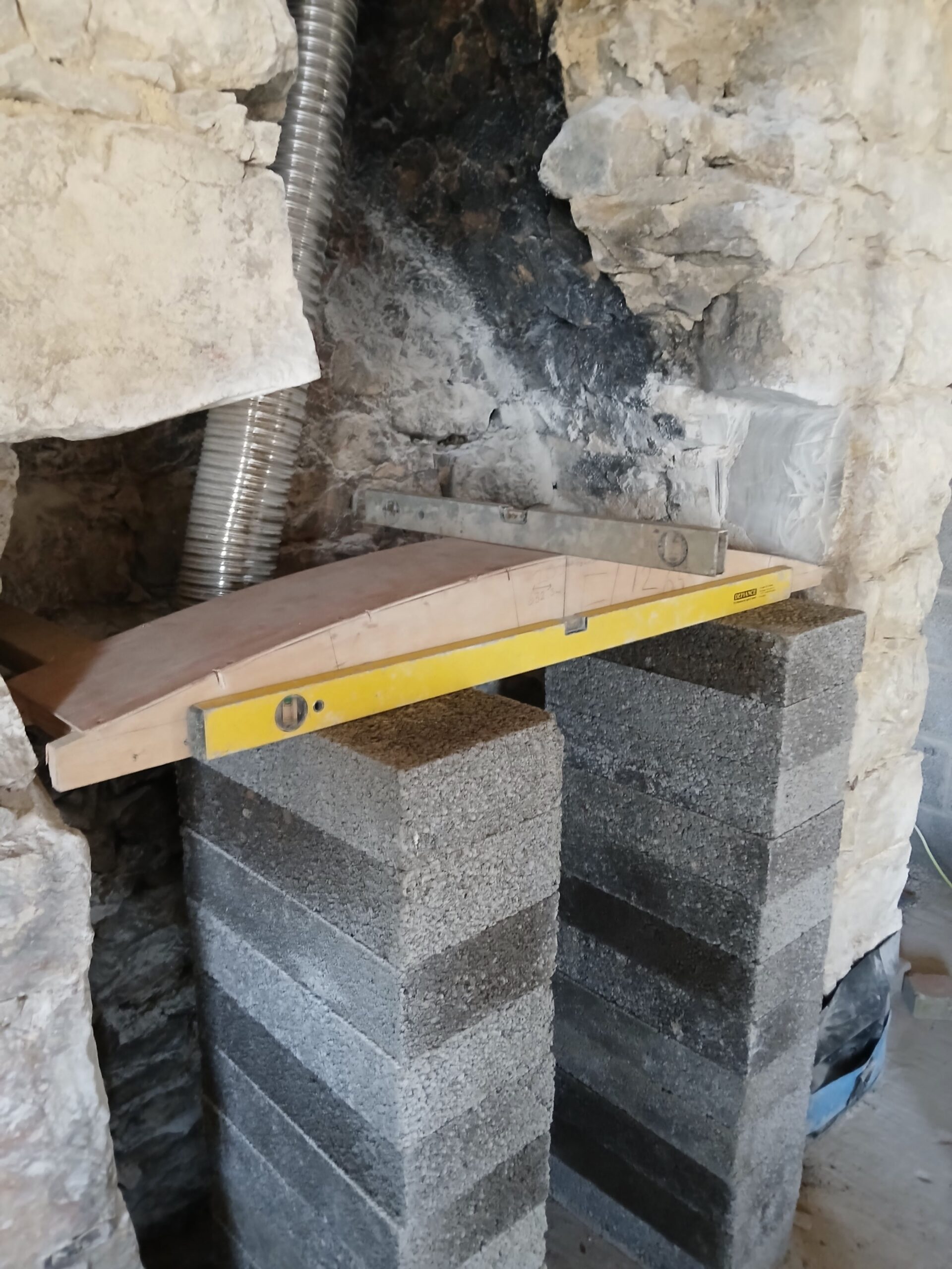 laying cement into a wall trench as the base foundaion for a cobbel stonewall
